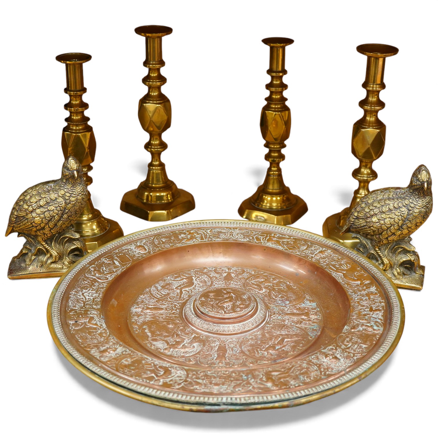 A group of copper and brassware to include candlesticks and an alms dish, 45cm in diameter